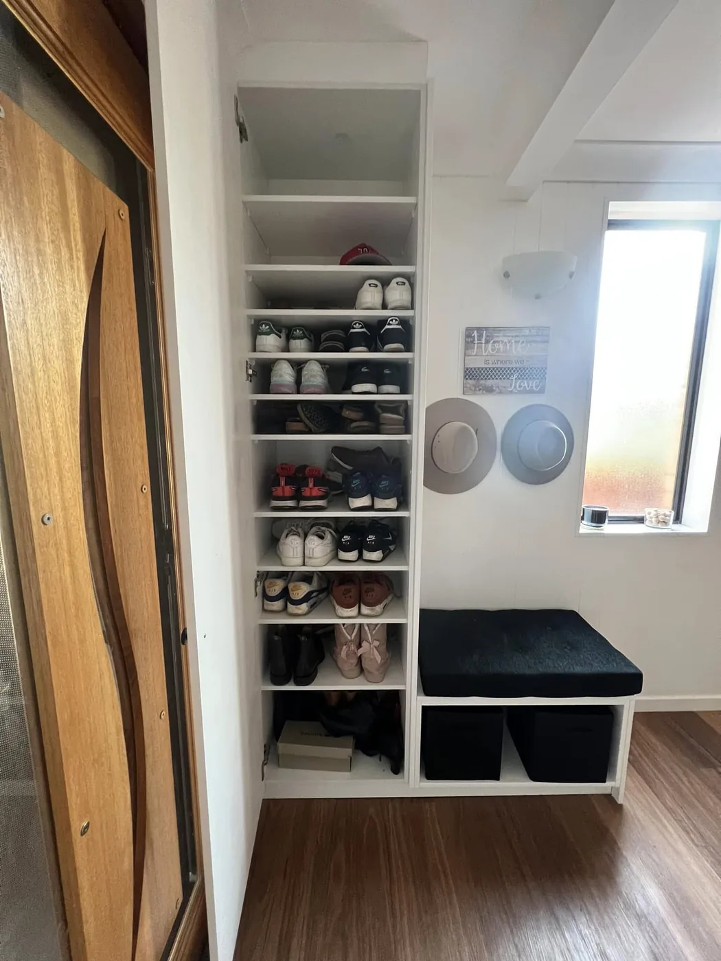 Custom entry closet with shoe storage and bench seat by S & J