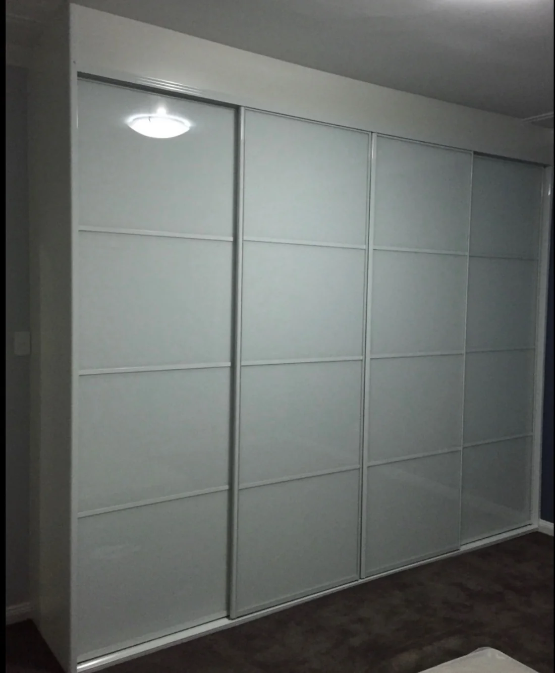 White frosted-glass sliding-door wardrobe