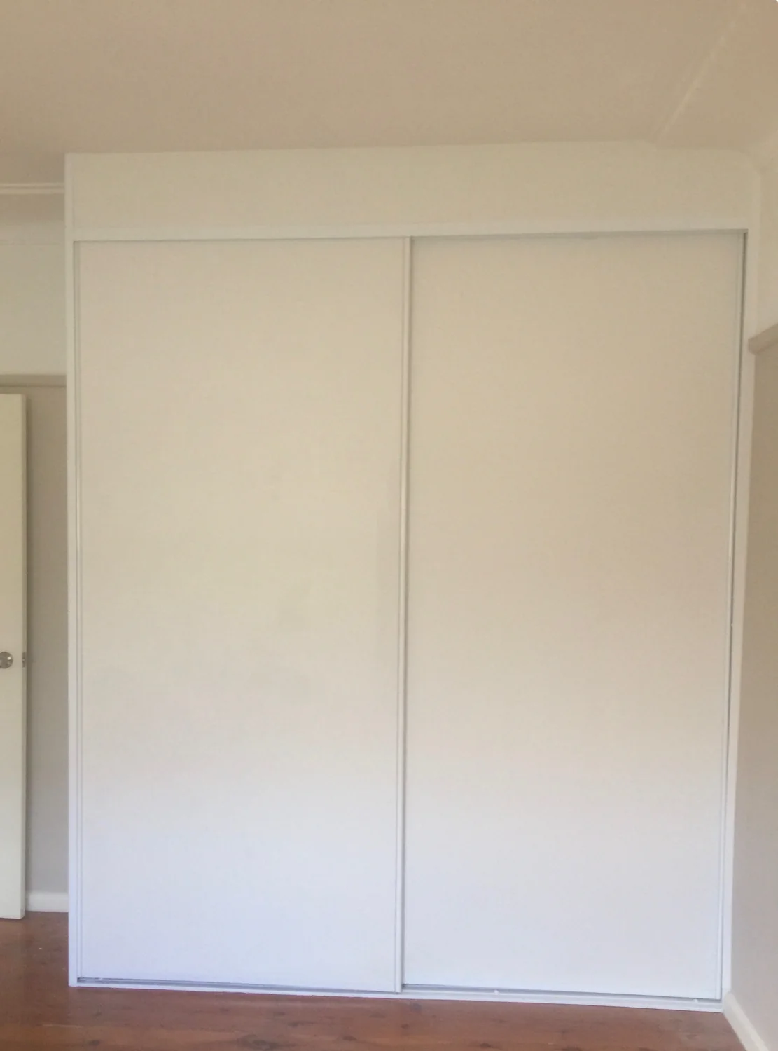 White sliding door built-in wardrobe