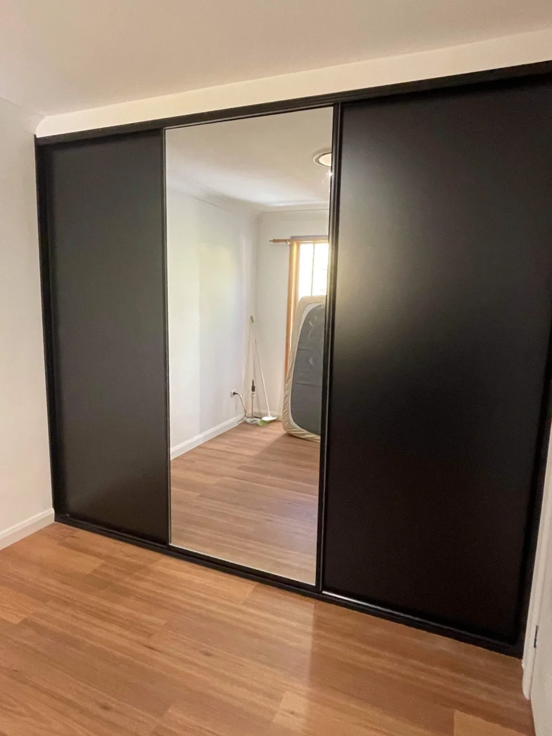 Black framed sliding doors with mirror panel