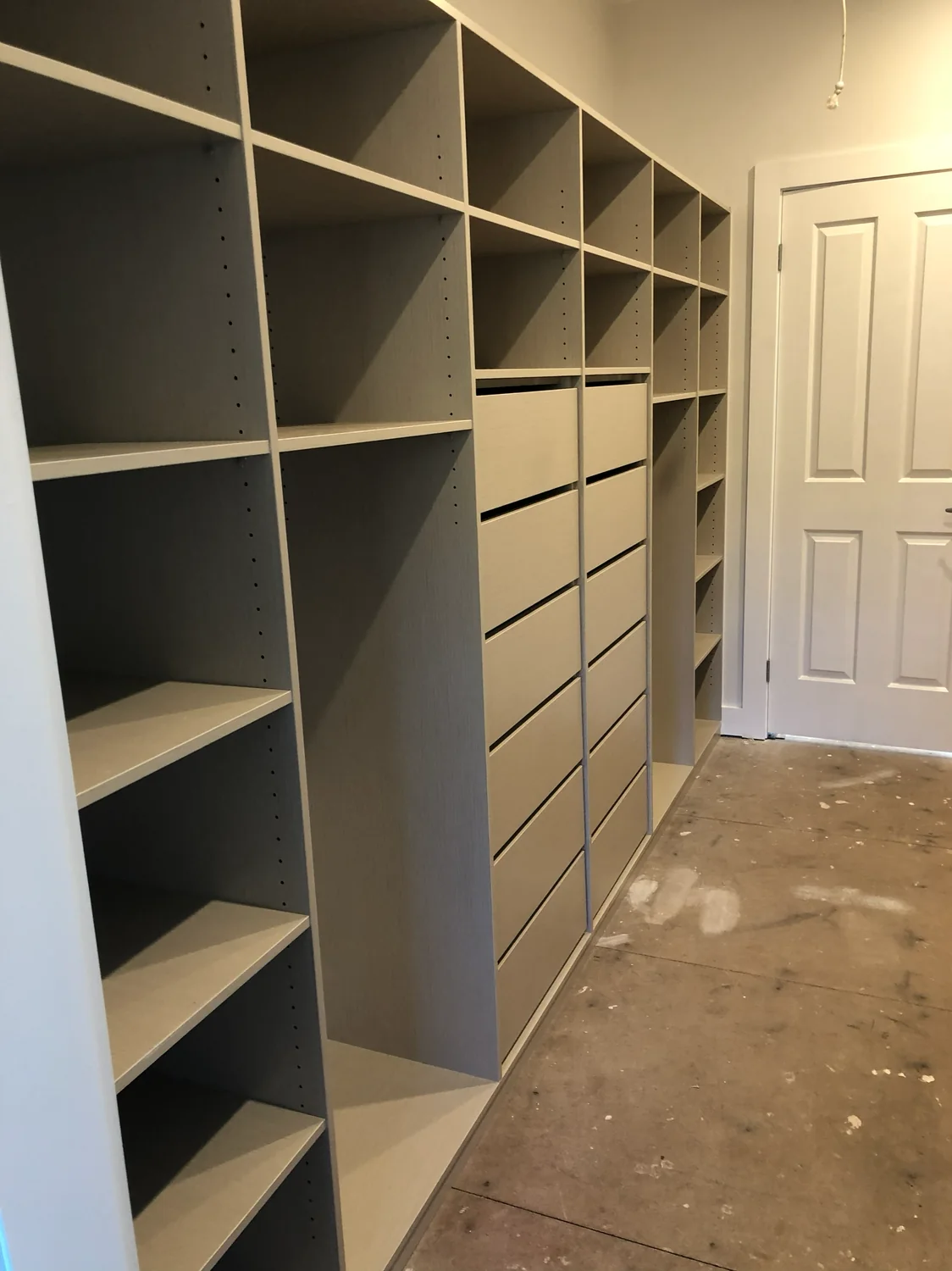 Custom walk-in robe with timber shelving and drawers